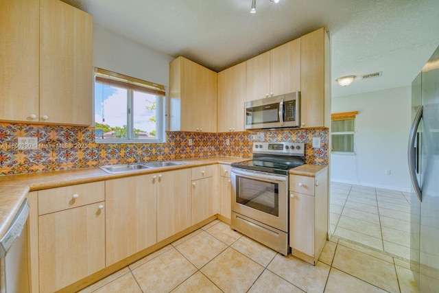 9018 SW 211th Ln, Cutler Bay, FL 33189 - kitchen with appliances with stainless steel finishes, light brown cabinets, a sink, backsplash, and light countertops