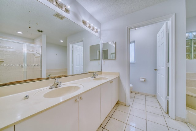 9018 SW 211th Ln, Cutler Bay, FL 33189 - bathroom featuring toilet, a stall shower, a textured ceiling, double vanity, and tile patterned floors
