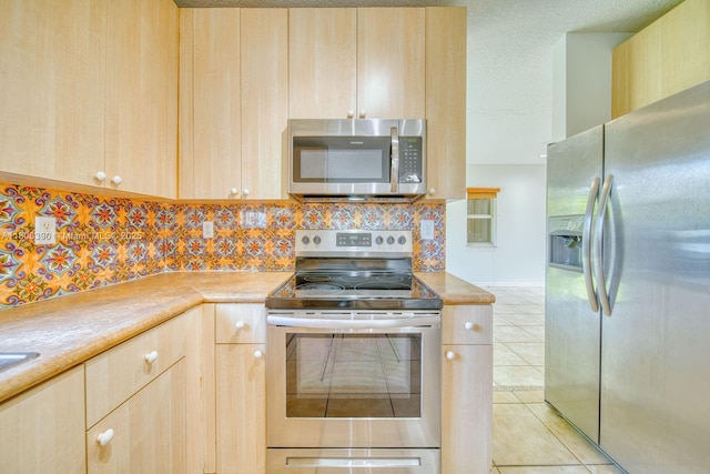 9018 SW 211th Ln, Cutler Bay, FL 33189 - kitchen featuring appliances with stainless steel finishes, light brown cabinetry, decorative backsplash, light countertops, and light tile patterned floors