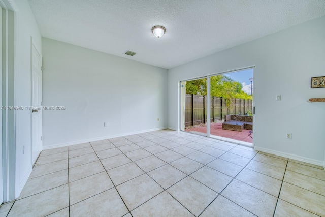 9018 SW 211th Ln, Cutler Bay, FL 33189 - empty room featuring a textured ceiling, light tile patterned floors, and baseboards