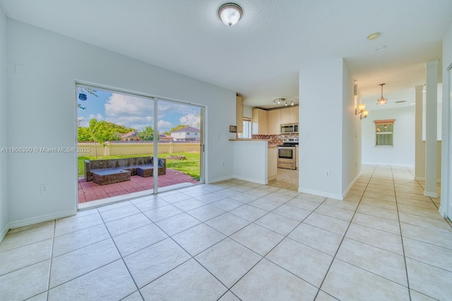 9018 SW 211th Ln, Cutler Bay, FL 33189 - unfurnished living room featuring light tile patterned floors and baseboards