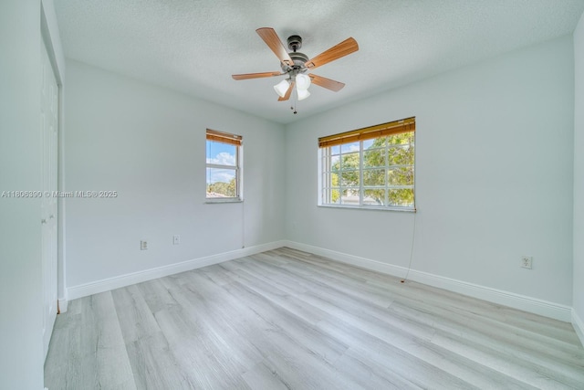 9018 SW 211th Ln, Cutler Bay, FL 33189 - spare room featuring light wood-style floors, ceiling fan, baseboards, and a textured ceiling