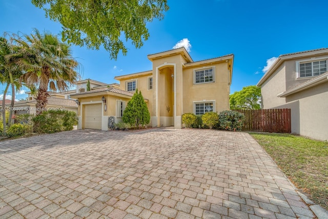 9018 SW 211th Ln, Cutler Bay, FL 33189 - mediterranean / spanish-style house with stucco siding, decorative driveway, and a garage