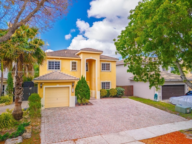 9018 SW 211th Ln, Cutler Bay, FL 33189 - mediterranean / spanish house with stucco siding, driveway, a tile roof, and a garage
