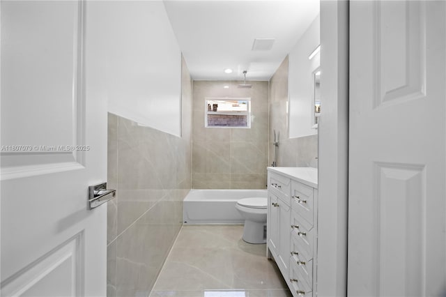 2608 NW 3rd St, Pompano Beach, FL 33069 - bathroom with tile walls, vanity, a combined bath / shower with rainfall shower, toilet, and tile patterned flooring