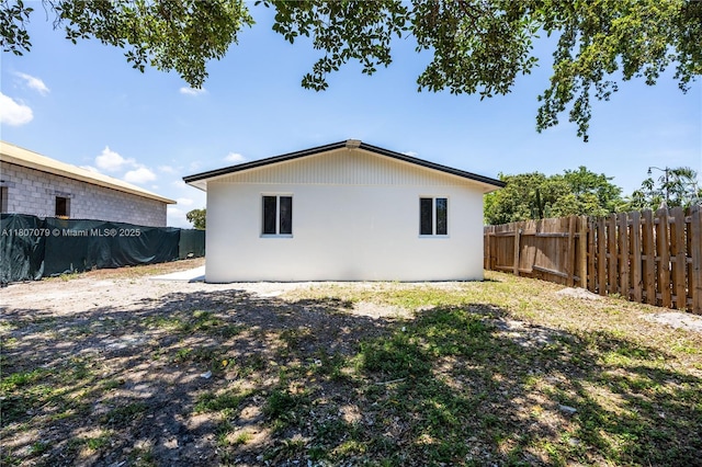 2608 NW 3rd St, Pompano Beach, FL 33069 - back of house with a fenced backyard and stucco siding