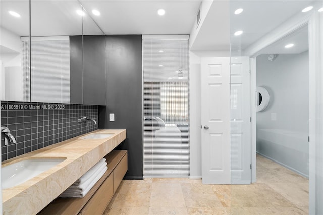 17100 N Bay Rd Unit 1608, Sunny Isles Beach, FL 33160 - bathroom featuring decorative backsplash, recessed lighting, double vanity, and baseboards