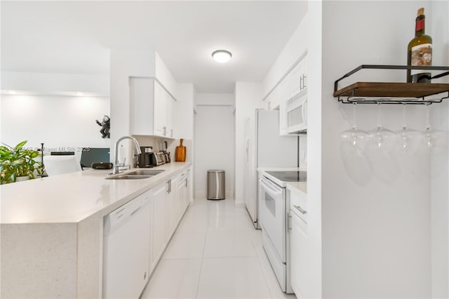 1155 Brickell Bay Dr Unit 2005, Miami, FL 33131 - kitchen with white appliances, a sink, light countertops, and white cabinets