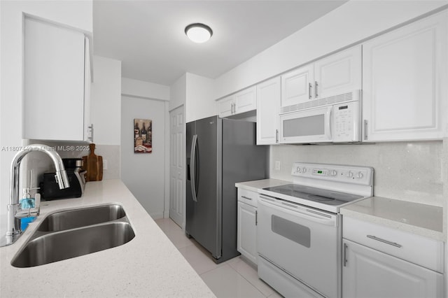 1155 Brickell Bay Dr Unit 2005, Miami, FL 33131 - kitchen with white appliances, a sink, white cabinetry, light tile patterned flooring, and light stone countertops