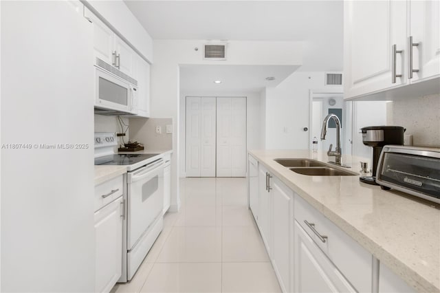 1155 Brickell Bay Dr Unit 2005, Miami, FL 33131 - kitchen with white appliances, a sink, light tile patterned floors, and white cabinetry