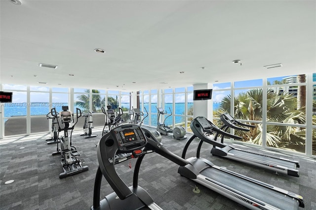 1155 Brickell Bay Dr Unit 2005, Miami, FL 33131 - workout area featuring a water view, healthy amount of natural light, a wall of windows, carpet floors, and recessed lighting