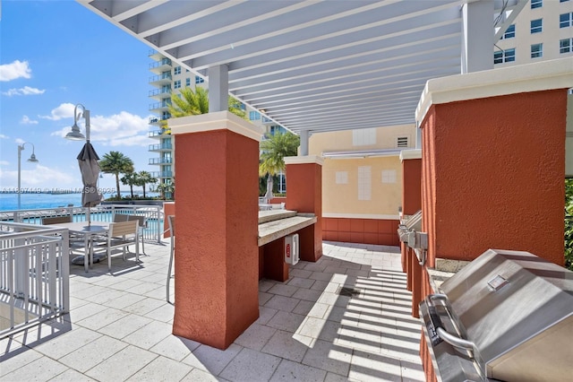 1155 Brickell Bay Dr Unit 2005, Miami, FL 33131 - view of patio featuring grilling area, a water view, and outdoor dining area