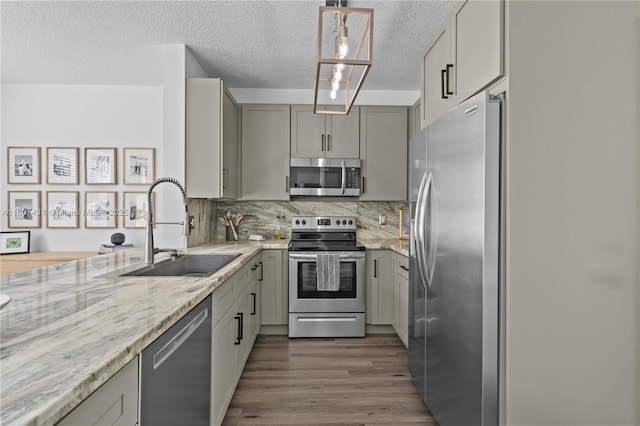 1437 NW 154th Ln, Pembroke Pines, FL 33028 - kitchen with appliances with stainless steel finishes, a sink, gray cabinetry, a textured ceiling, and dark wood-style flooring