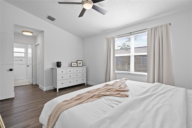 1437 NW 154th Ln, Pembroke Pines, FL 33028 - bedroom with multiple windows, wood finished floors, a textured ceiling, ceiling fan, and baseboards