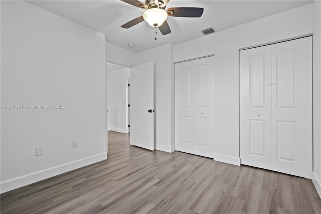 1437 NW 154th Ln, Pembroke Pines, FL 33028 - unfurnished bedroom with wood finished floors, two closets, baseboards, and a ceiling fan