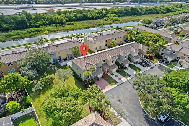 1437 NW 154th Ln, Pembroke Pines, FL 33028 - aerial perspective of suburban area featuring a nearby body of water and a tree filled landscape