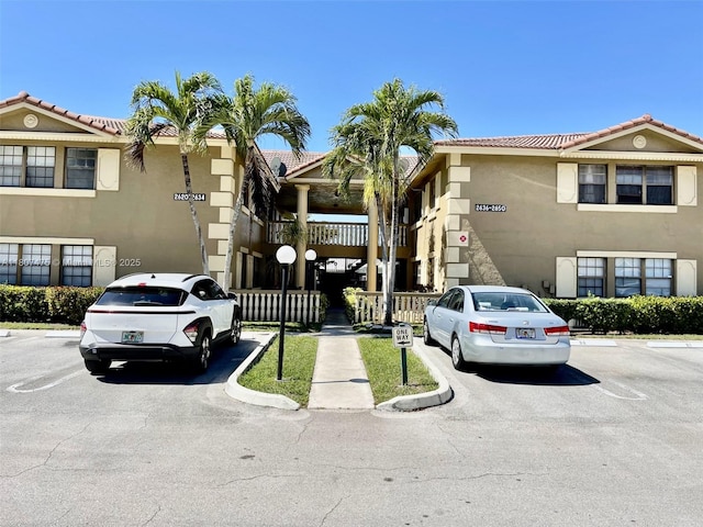 2624 Riverside Dr Unit 2624, Coral Springs, FL 33065 - view of building exterior with uncovered parking