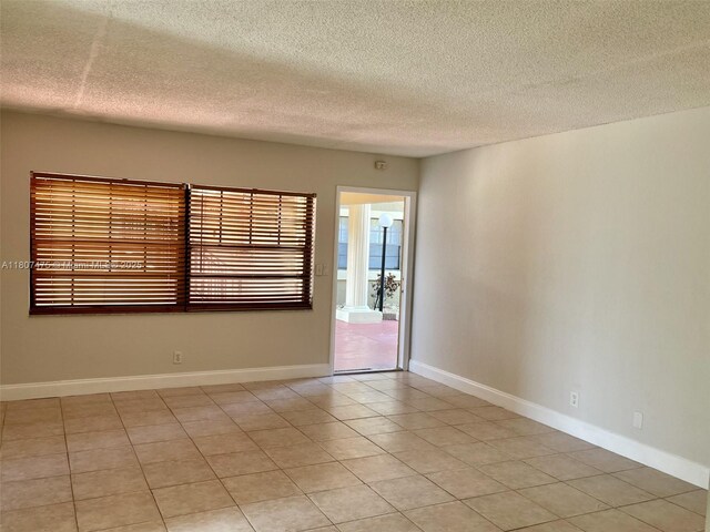 2624 Riverside Dr Unit 2624, Coral Springs, FL 33065 - unfurnished room with a textured ceiling and light tile patterned floors