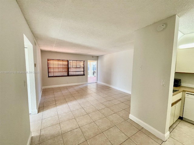 2624 Riverside Dr Unit 2624, Coral Springs, FL 33065 - unfurnished room featuring a textured ceiling, light tile patterned floors, and baseboards