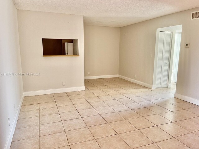 2624 Riverside Dr Unit 2624, Coral Springs, FL 33065 - spare room featuring light tile patterned floors and a textured ceiling
