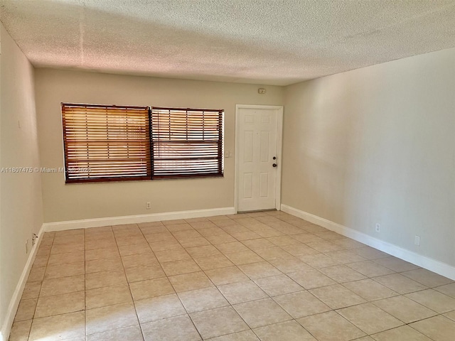 2624 Riverside Dr Unit 2624, Coral Springs, FL 33065 - spare room featuring a textured ceiling and light tile patterned floors