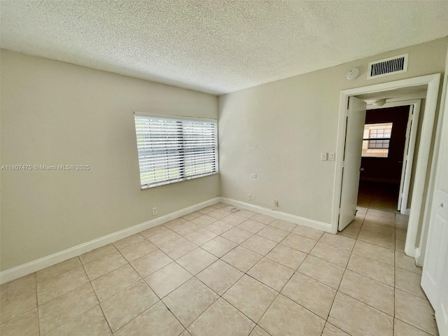 2624 Riverside Dr Unit 2624, Coral Springs, FL 33065 - unfurnished room featuring a textured ceiling, light tile patterned flooring, baseboards, and a smoke detector