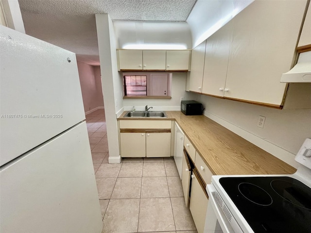 2624 Riverside Dr Unit 2624, Coral Springs, FL 33065 - kitchen with white appliances, a sink, light tile patterned flooring, light countertops, and cream cabinets