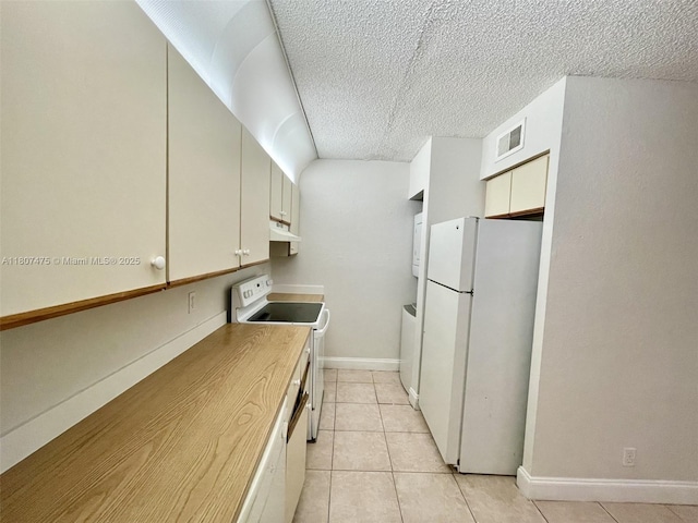 2624 Riverside Dr Unit 2624, Coral Springs, FL 33065 - kitchen with white appliances, under cabinet range hood, light tile patterned flooring, a textured ceiling, and baseboards