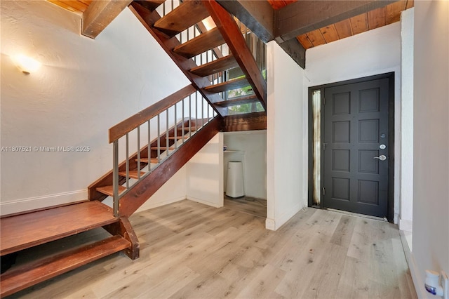 19412 NE 26th Ave Unit 143B, Miami, FL 33180 - foyer entrance featuring stairs, wood finished floors, wood ceiling with exposed beams, and baseboards