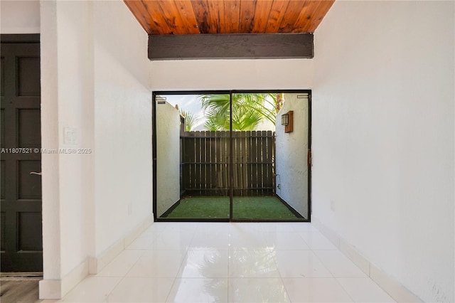 19412 NE 26th Ave Unit 143B, Miami, FL 33180 - unfurnished room featuring wood ceiling, golf simulator, baseboards, and tile patterned flooring