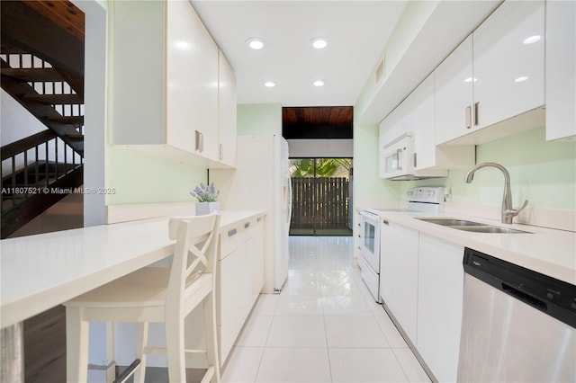 19412 NE 26th Ave Unit 143B, Miami, FL 33180 - kitchen with white appliances, a sink, recessed lighting, white cabinetry, and light countertops