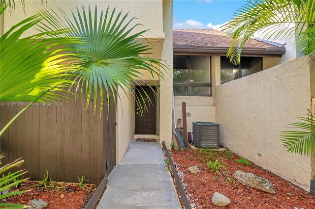 19412 NE 26th Ave Unit 143B, Miami, FL 33180 - property entrance featuring stucco siding and cooling unit