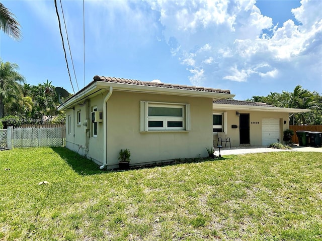 2040 N Hibiscus Dr, North Miami, FL 33181 - view of front of house with stucco siding, an attached garage, and a tiled roof