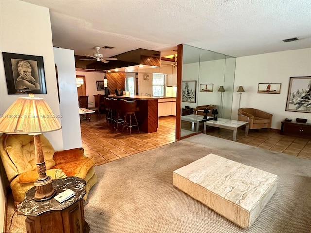 2040 N Hibiscus Dr, North Miami, FL 33181 - carpeted living room featuring tile patterned flooring, a textured ceiling, and ceiling fan