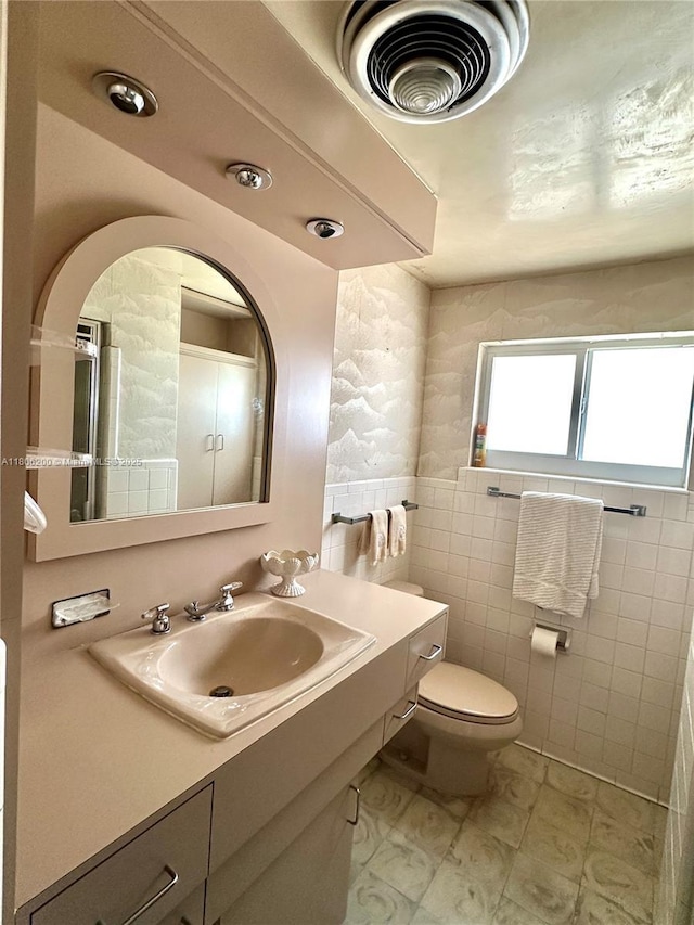 2040 N Hibiscus Dr, North Miami, FL 33181 - bathroom featuring vanity, toilet, and tile walls