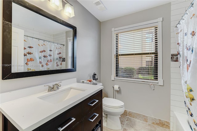 133 NW 98th Ter, Plantation, FL 33324 - full bath featuring toilet, vanity, baseboards, and stone finish floors