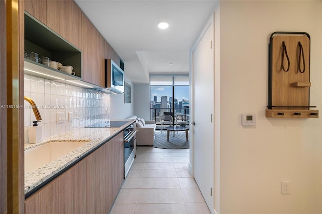 601 NE 1st Ave Unit 3507, Miami, FL 33132 - kitchen featuring open shelves, stainless steel appliances, light stone countertops, modern cabinets, and a sink