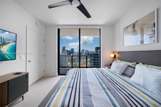 601 NE 1st Ave Unit 3507, Miami, FL 33132 - bedroom with a wall of windows, access to outside, light tile patterned floors, a skyline view, and ceiling fan