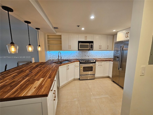 2625 Collins Ave Unit 1408, Miami Beach, FL 33140 - kitchen with butcher block countertops, appliances with stainless steel finishes, a sink, open shelves, and tasteful backsplash