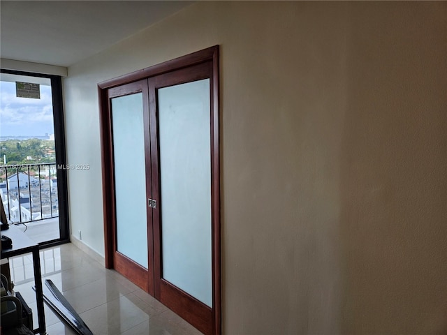 2625 Collins Ave Unit 1408, Miami Beach, FL 33140 - doorway featuring expansive windows, baseboards, and light tile patterned flooring