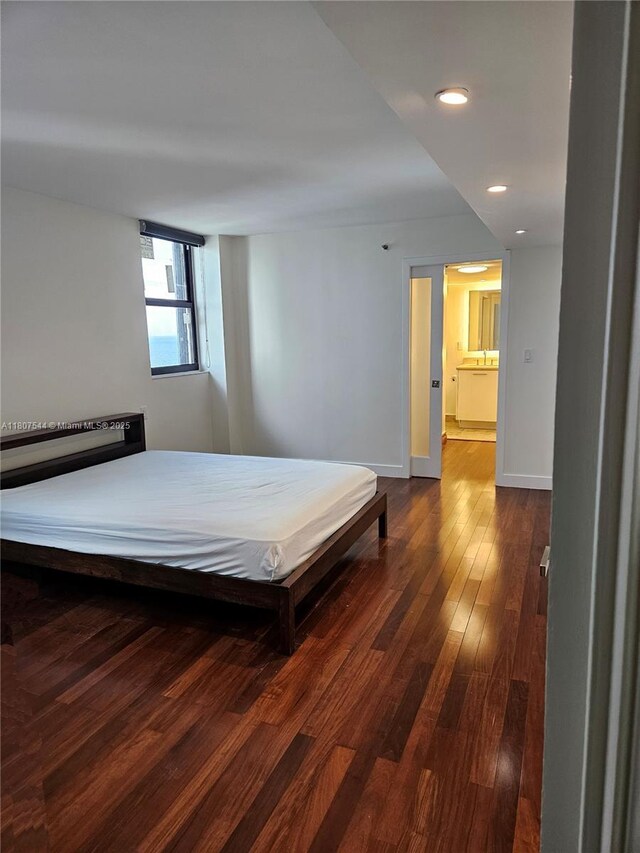 2625 Collins Ave Unit 1408, Miami Beach, FL 33140 - bedroom featuring dark wood-style flooring, recessed lighting, and baseboards