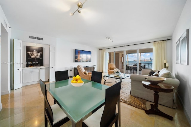 5235 Fisher Island Dr Unit 5235, Miami Beach, FL 33109 - dining area with rail lighting, light tile patterned floors, and baseboards