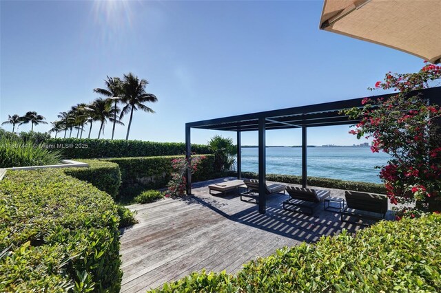5235 Fisher Island Dr Unit 5235, Miami Beach, FL 33109 - wooden deck featuring a water view, an outdoor hangout area, and a pergola