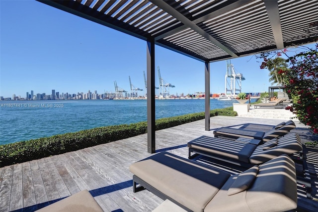 5235 Fisher Island Dr Unit 5235, Miami Beach, FL 33109 - view of patio featuring a pergola, a deck with water view, and a view of skyline