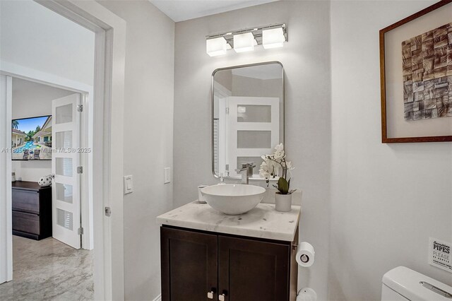 16301 SW 62nd St, Southwest Ranches, FL 33331 - half bathroom with vanity, toilet, and baseboards