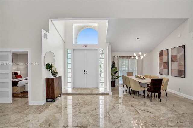 16301 SW 62nd St, Southwest Ranches, FL 33331 - entryway with high vaulted ceiling, marble tiled floors, a chandelier, and baseboards