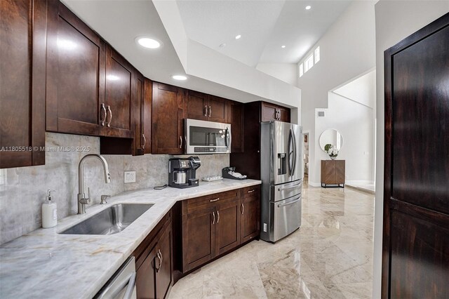 16301 SW 62nd St, Southwest Ranches, FL 33331 - kitchen featuring appliances with stainless steel finishes, a sink, light marble finish floors, decorative backsplash, and recessed lighting