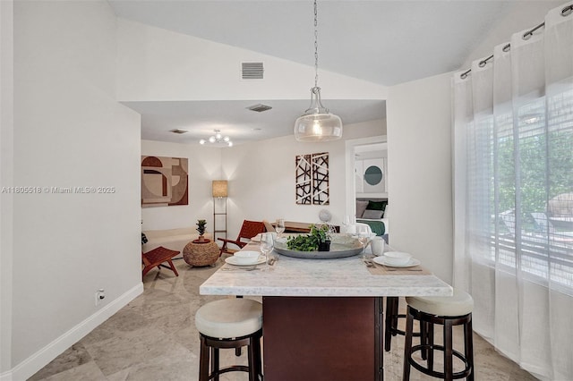 16301 SW 62nd St, Southwest Ranches, FL 33331 - kitchen with lofted ceiling, a breakfast bar, light countertops, baseboards, and hanging light fixtures