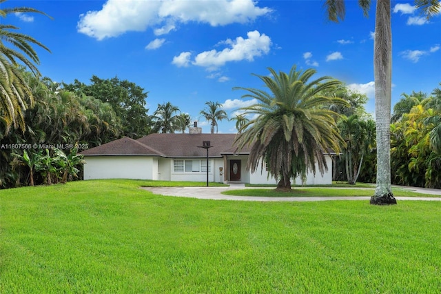 5310 SW 172nd Ave, Southwest Ranches, FL 33331 - view of front facade featuring a front yard, stucco siding, and a chimney