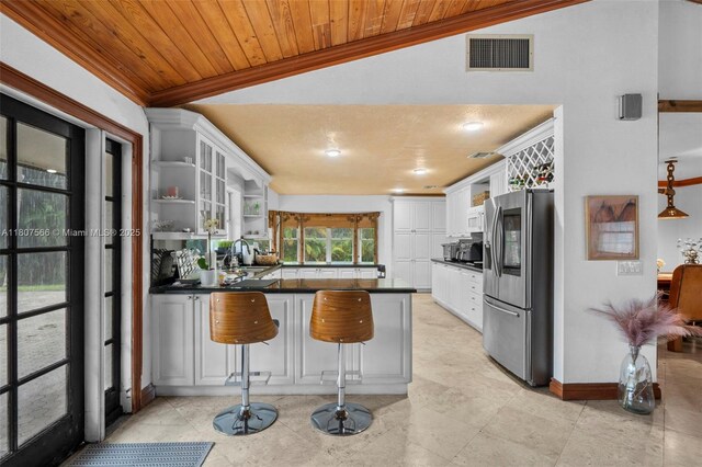 5310 SW 172nd Ave, Southwest Ranches, FL 33331 - kitchen with stainless steel fridge with ice dispenser, open shelves, a peninsula, dark countertops, and a sink
